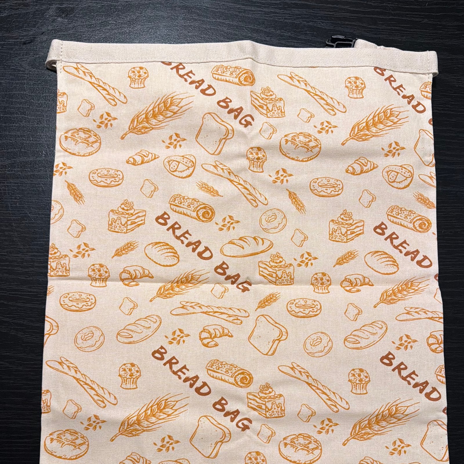 Beeswax bread bag flat lay — printed cotton exterior with bread pattern